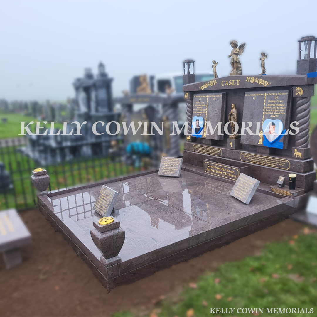Paradiso granite double book Traveller headstone with statues, gold leaf inscription and heart plaques in Mount St Oliver Cemetery, Limerick