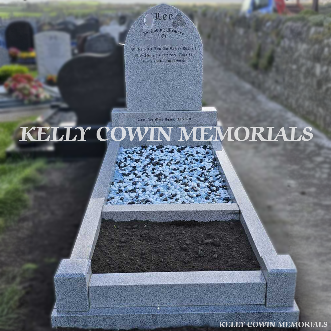 Front view of grey granite pointed headstone with kerbing and garden bar