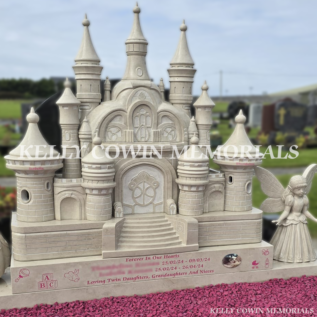 Detailed stone princess castle headstone with carved towers and pink lettering installed in County Clare.