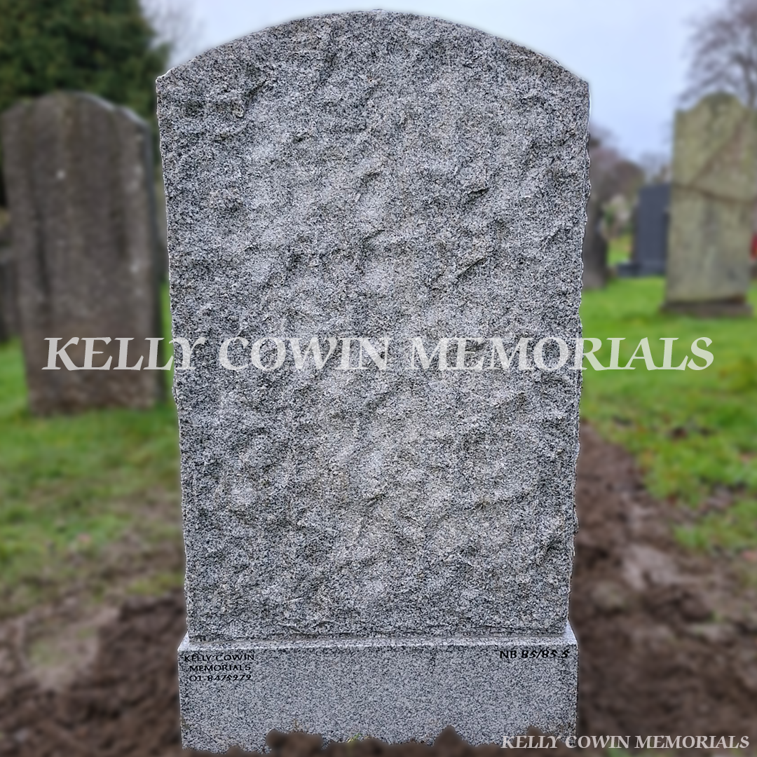 Back view of a Grey granite rough boulder headstone with flower box and black inscription in Glasnevin Cemetery Dublin by Kelly Cowin Memorials