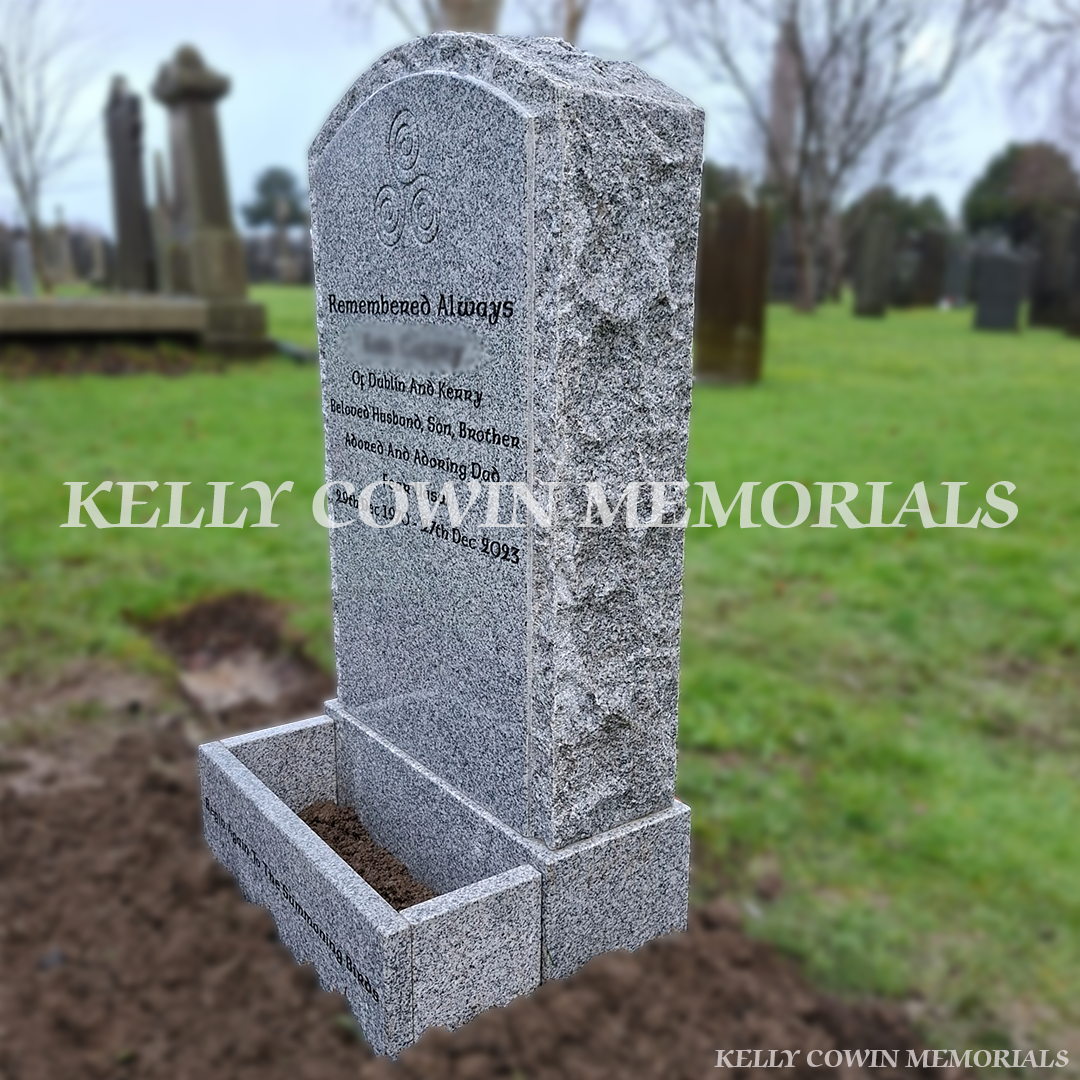side view of Grey granite rough boulder headstone with flower box and black inscription in Glasnevin Cemetery Dublin by Kelly Cowin Memorials
