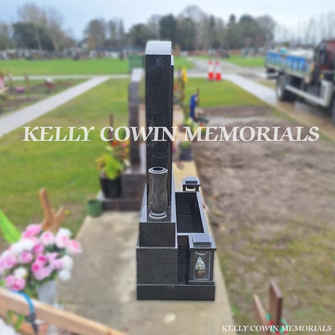 Side view showing lanterns, flower box and vases on Rustenburg granite memorial