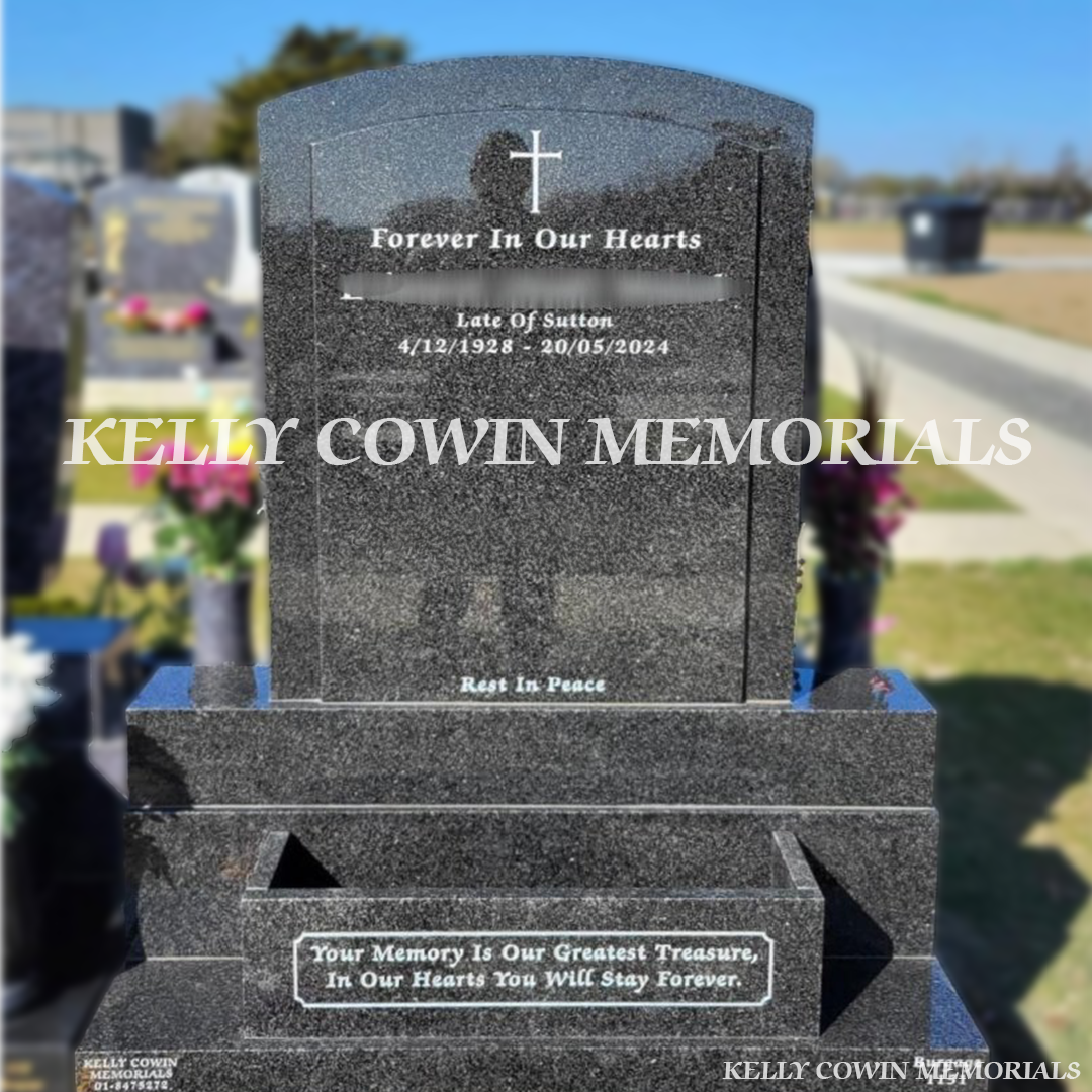 Front view of Rustenburg polished boulder headstone with raised face and white inscription in Balgriffin Cemetery Dublin