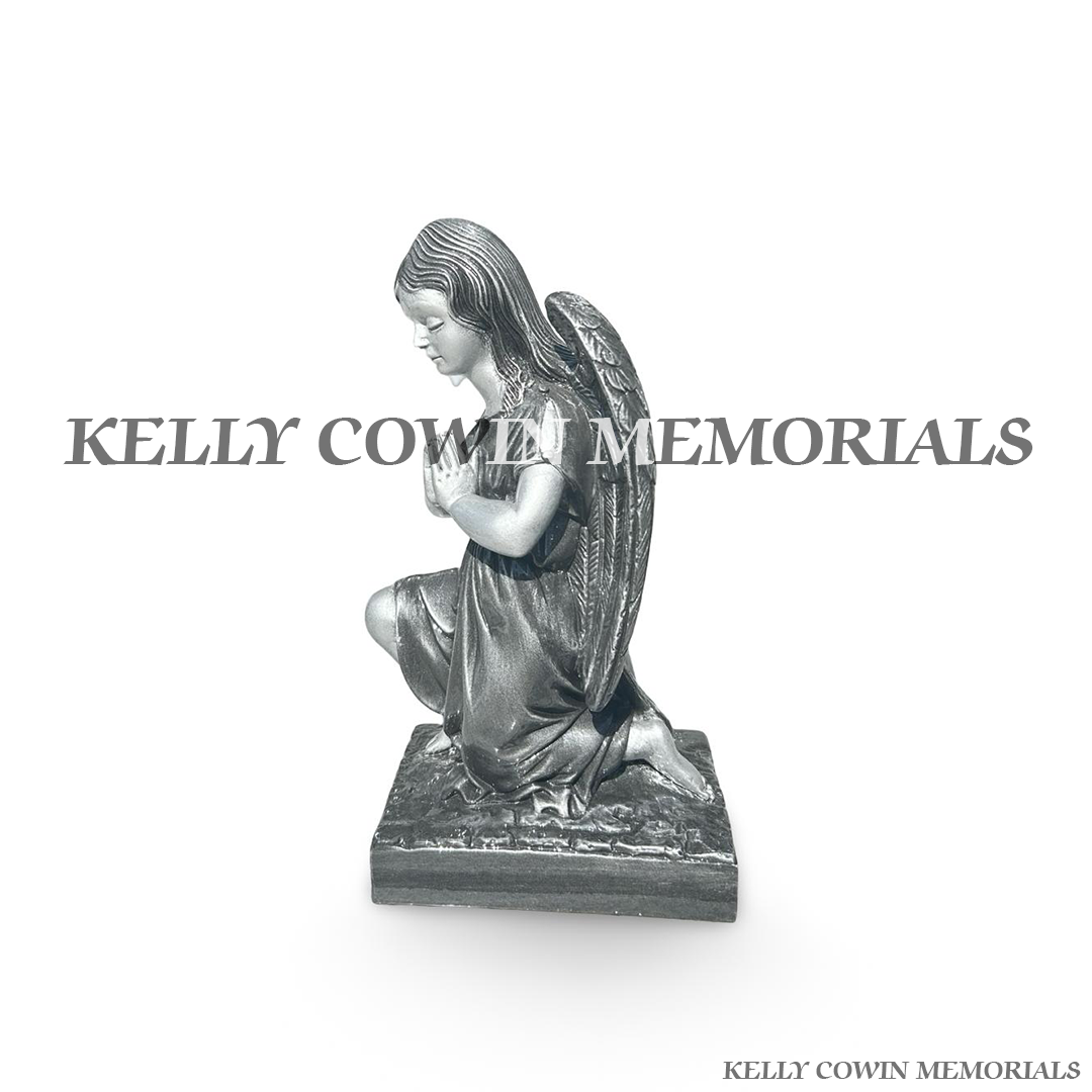 Side view of silver angel statues for memorial graves