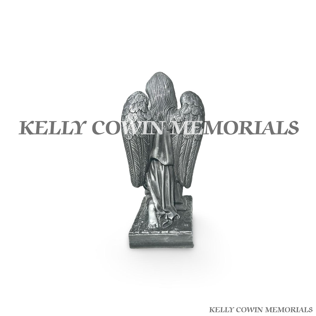 Back view of silver angel statues for memorial graves