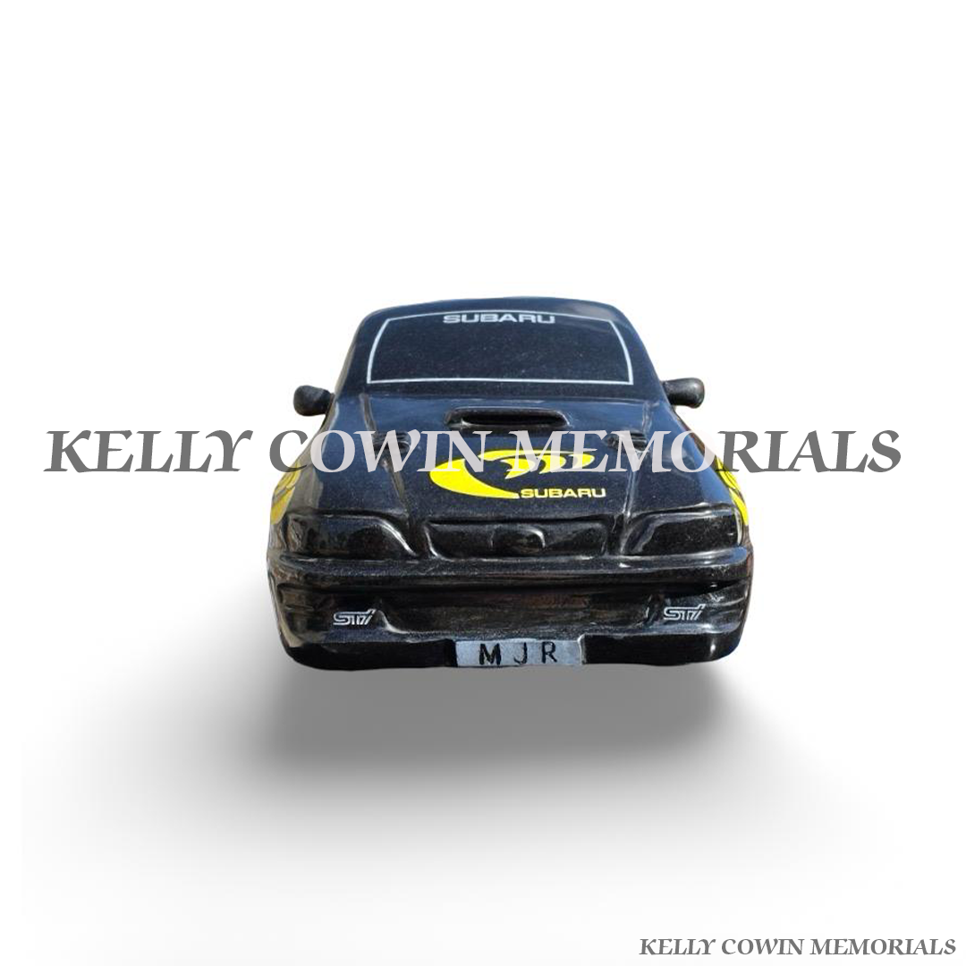 Front view of custom black granite Subaru memorial car with detailed bonnet, headlights and personalised number plate.