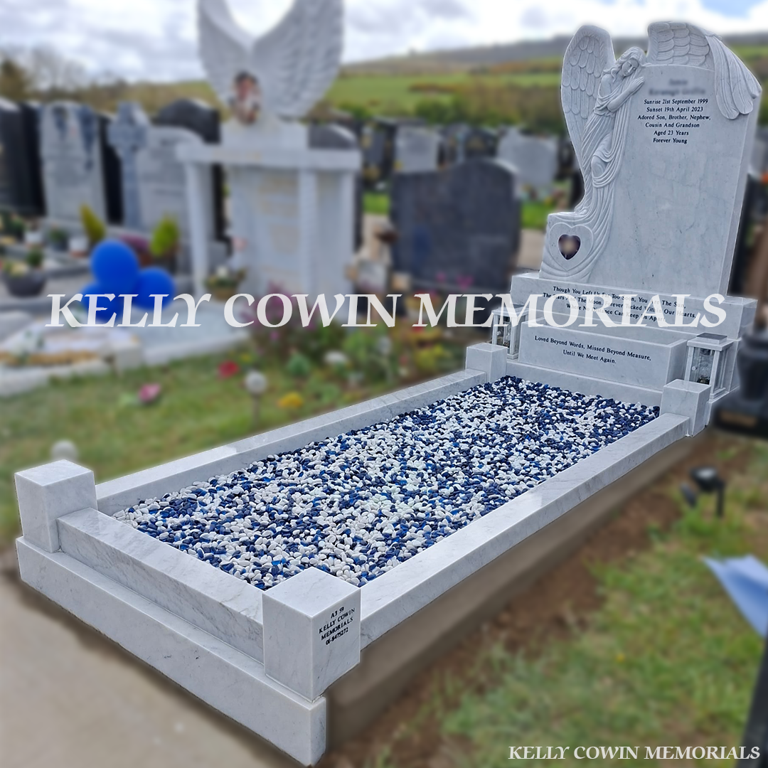 Side view of white marble memorial with kerbing and chippings
