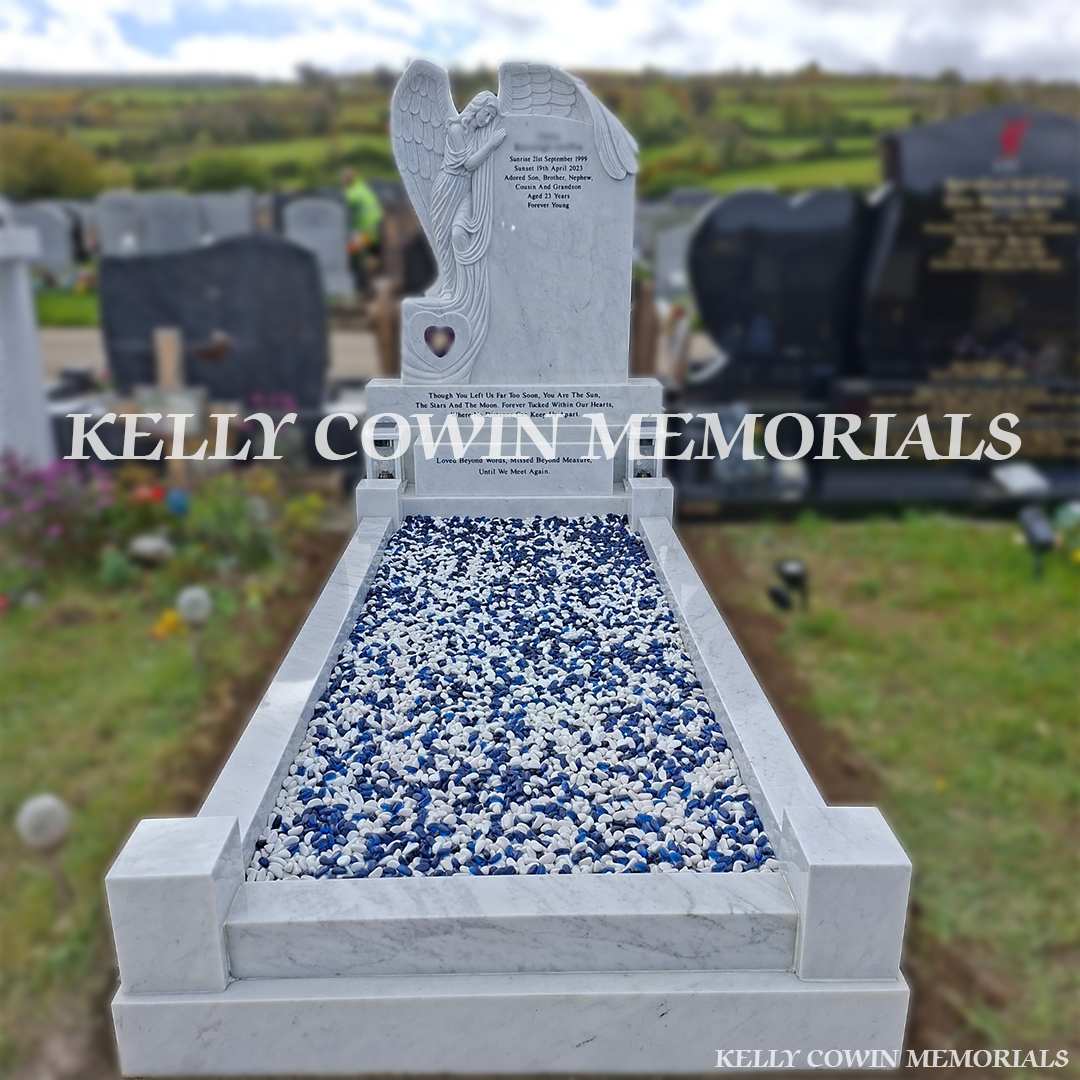 Front view of white marble angel headstone with black inscription in Bohernabreena Cemetery