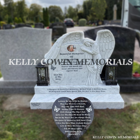 White marble angel headstone with carved wings, ceramic photo, two Blue Lagoon solar lanterns and heart plaque in Piltown Cemetery,