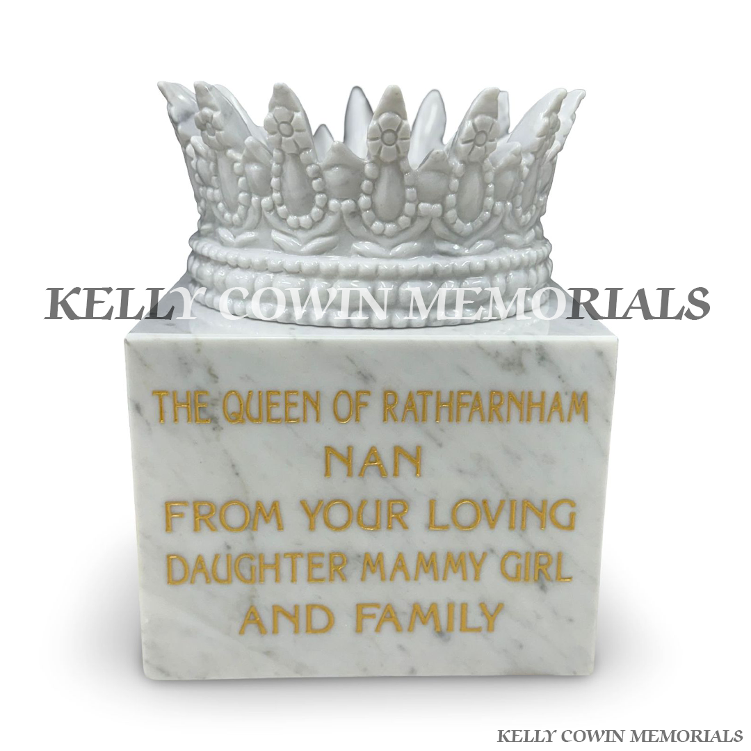 Front view of white marble crown memorial ornament with gold lettering