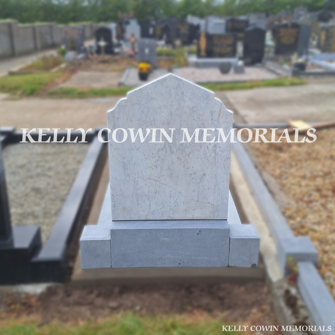 Side view of white marble and limestone memorial with mixed chippings