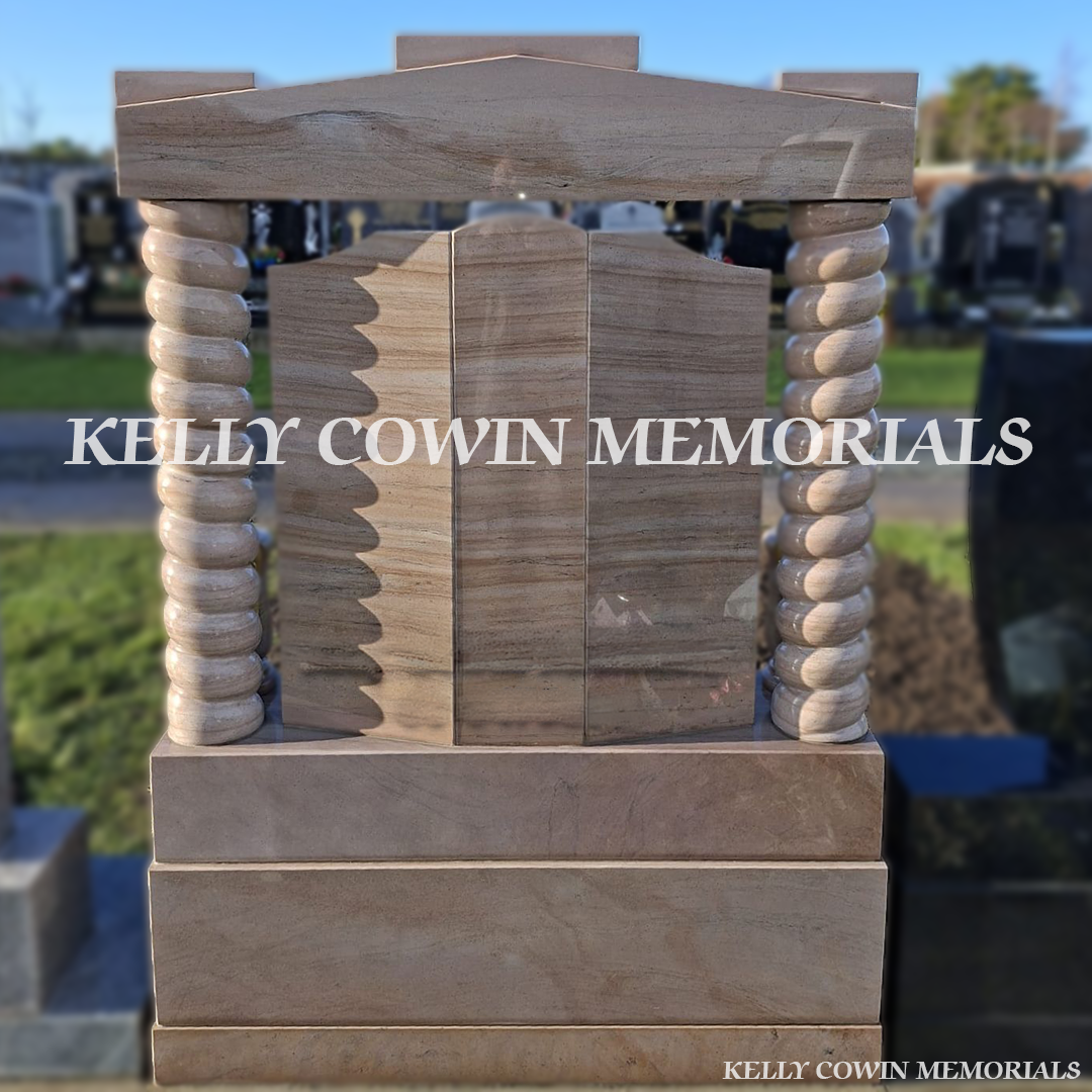 Back view of Woodlawn granite memorial with twisted pillars and bronze statues